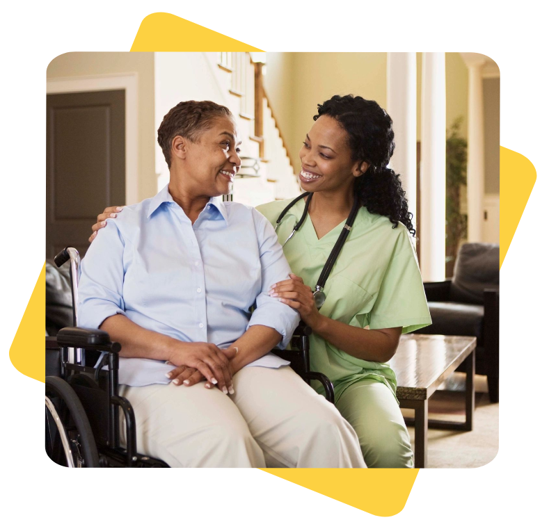 A nurse and an elderly woman in a wheelchair.